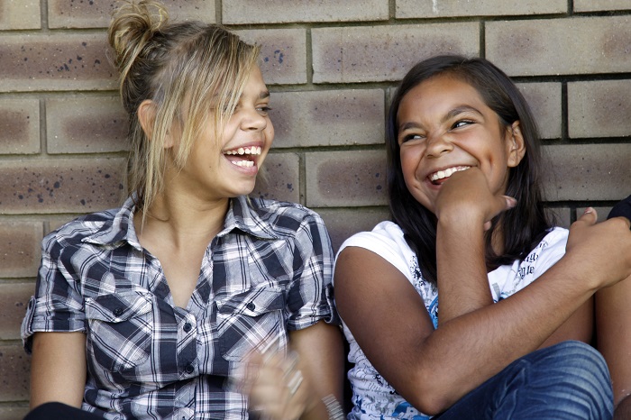 Two teenage Aboriginal girls laughing